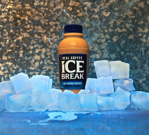 A closeup shot of an ice break coffee bottle decorated with some ice cubes