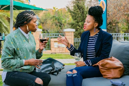 A number of VIP guests mingling at an outdoor social event in Johannesburg, South Africa