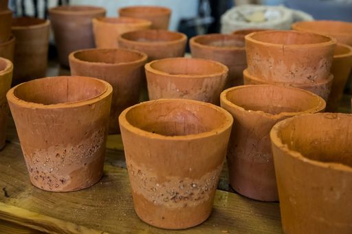 A several pots made of clay on a wooden surface