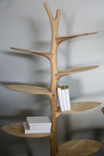 A vertical shot of a wooden bookshelf with some books on it