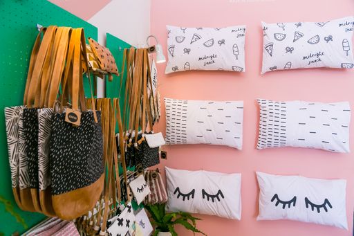 A set of cute pillows and bags hanging on a wall