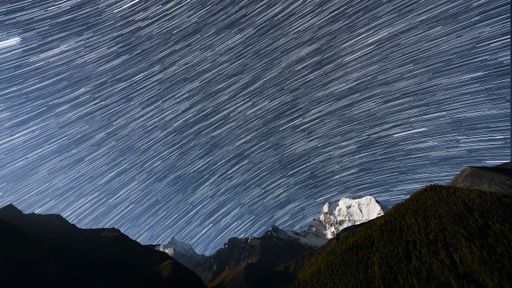 A landscape of Yangmaiyong under a starry sky with long exposure in Sichuan, China