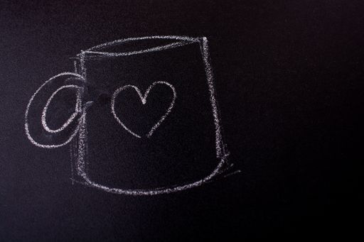 A view of a blackboard and a picture of a mug with a heart on it done with chalk