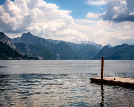 A beautiful view of the mountains under a cloudy sky at the Tegernsee lake