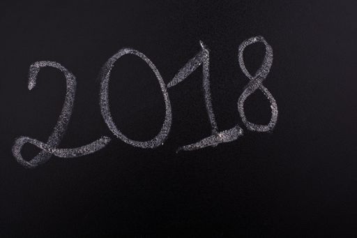 A view of a blackboard and a text of "2018" written on it with white-colored chalk