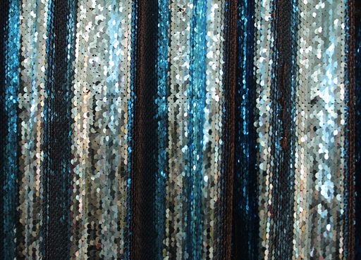 A closeup shot of surfaces and textures of folded fabrics cloth found at a fabrics market