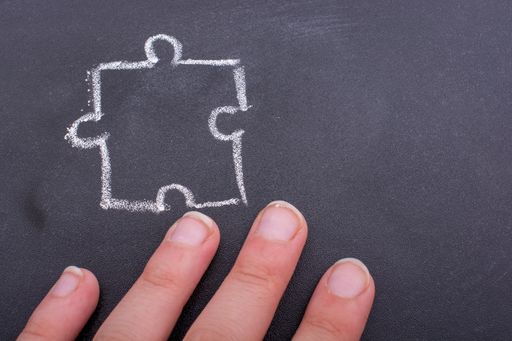 A closeup shot of a piece of a puzzle drawn on the blackboard