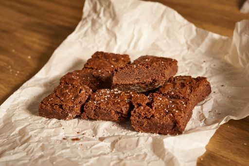 A closeup of brownies on a white tissue paper