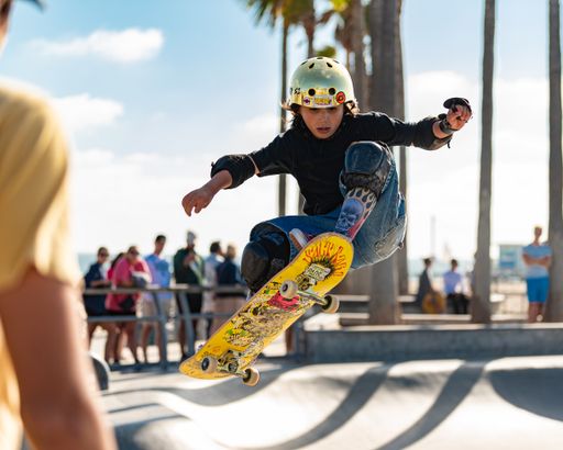 A person performing skateboard tricks at Venice Beach skate park