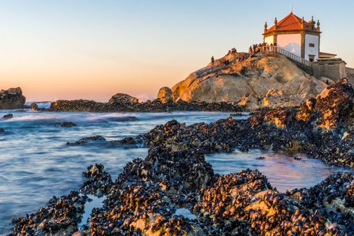 A view of the beautiful Vista Sobre Senhora Da Pedra near the sea with small stones in Portugal