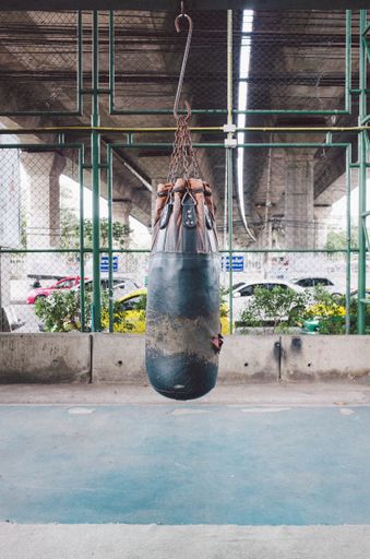 A vertical photo of a punching bag hanging from ceiling