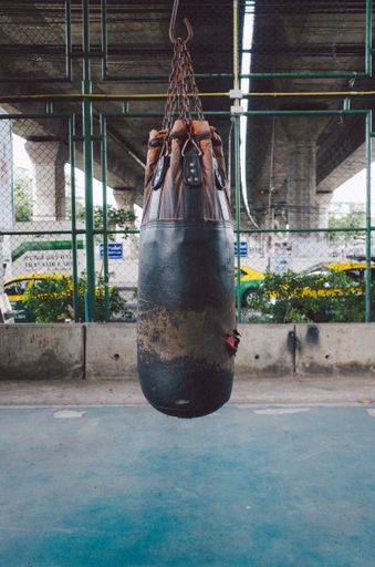 A vertical photo of a punching bag hanging from ceiling