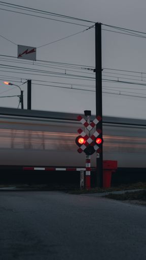 A vertical shot of the traffic lights against the rushing train.