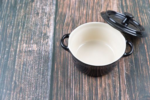 A closeup of a small pot on a wooden table