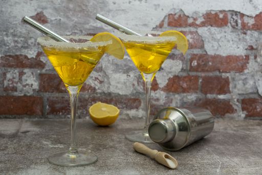 refreshing squeezed lemon cocktail with ice and cocktail shaker