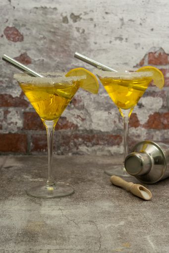 refreshing squeezed lemon cocktail with ice and cocktail shaker