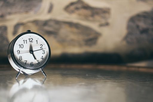 Vintage analog clock showing time with negative space on the right.