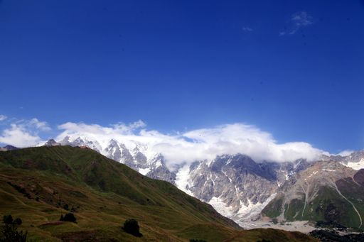 A beautiful view of the mountains gleaming under the blue sky