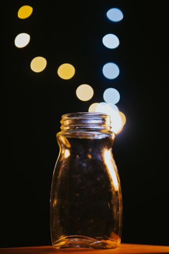 A closeup of a jar on a wooden table with soft focus background