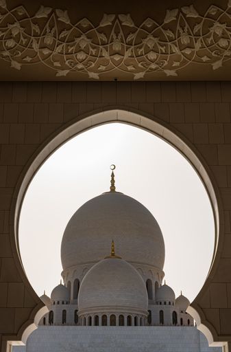 Visitors at the Sheikh Zayed Grand Mosque in the capital city of Abu Dhabi, United Arab Emirates. It is the largest mosque in the UAE