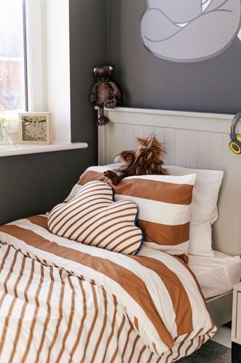A vertical shot of a bed in a children's room
