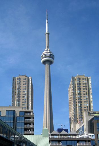 A vertical shot of the CN Tower in Toronto, Canada against blue sky