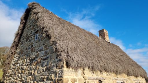 A stone cottage with thatched roof in Beamish, United Kingdom