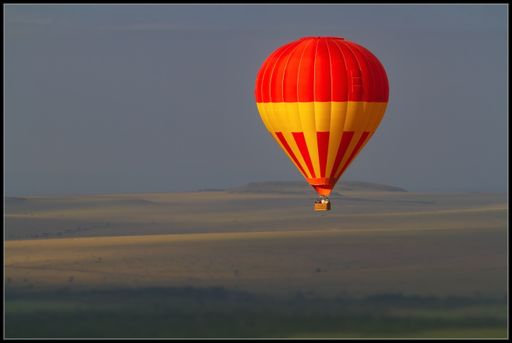 A hot air balloon flying in Kenya during daylight
