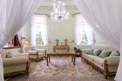 A cozy living room in a classic house with old furniture in Cuba