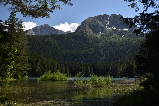 A stunning view of the Crno Jezero Lake in Montenegro, surrounded by picturesque mountain ranges