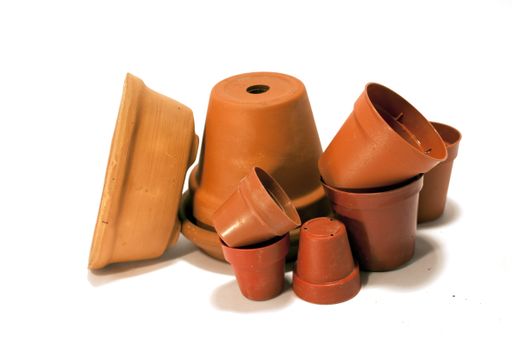 A closeup shot of empty flowerpots under the lights isolated on a white background
