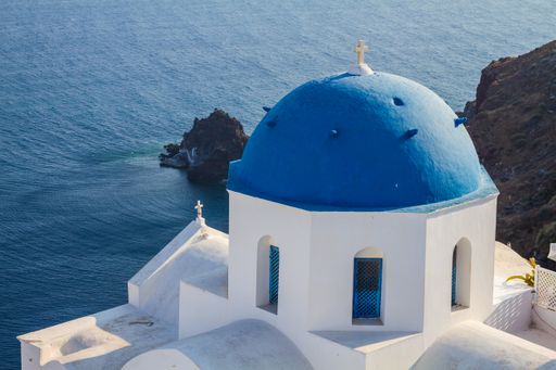 The iconic blue dome church in the island of Santorini in Greece