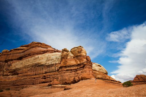 A beautiful shot of a person running towards the deserted cliff under a cloudy sky