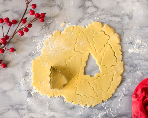 A closeup of a pastry with a Christmas tree shape on a wooden table