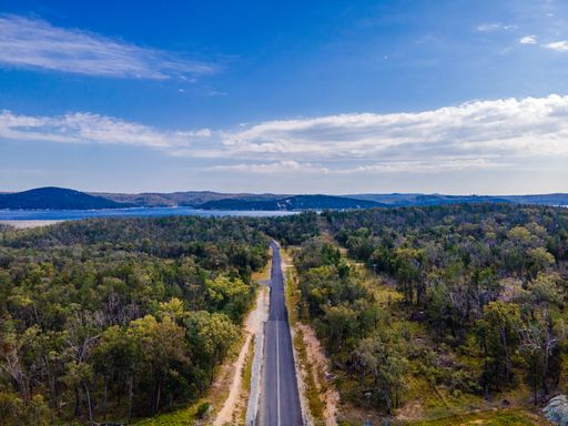 The aerial view of the highway under the sky at Copeton Dam Waters out near Inverell, Australia