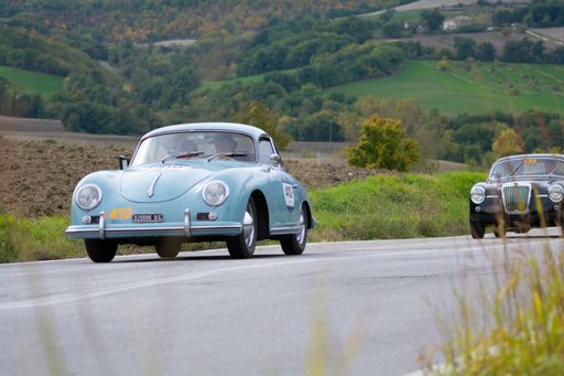 A closeup of an old racing car in rally Mille Miglia the famous italian historical race