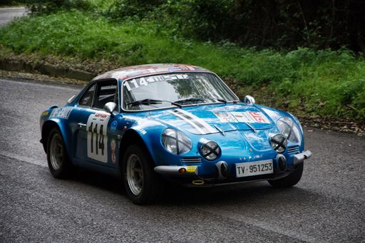 A closeup of an old racing car in rally Mille Miglia the famous italian historical race