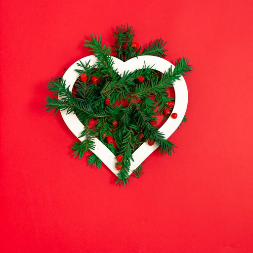 A Christmas tree decorated with white heart on a red background