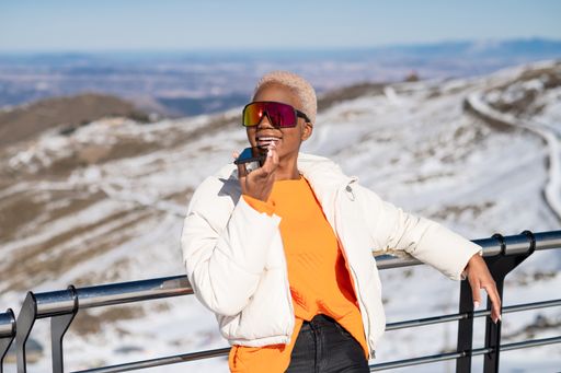 A closeup of the young African American woman talking on the phone at a winter resort.