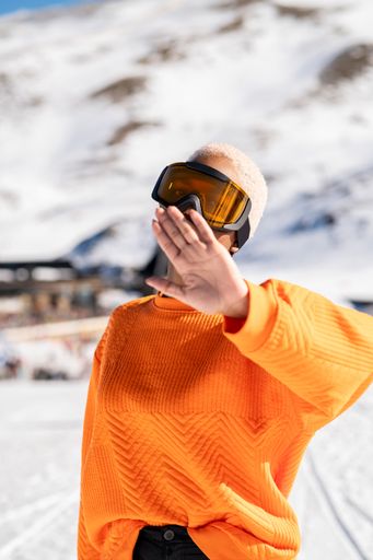 A vertical closeup of the young African American woman at a winter resort.