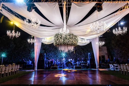 A beautiful shot of an elegant outdoor wedding reception at night