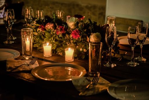 A closeup shot of romantic dinner set up with candles and flower
