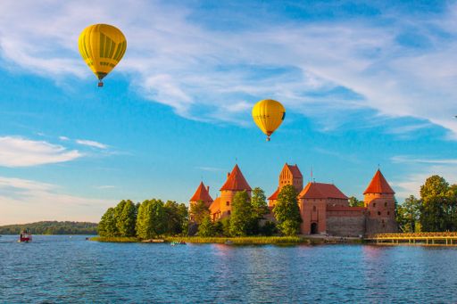 A beautiful view of air balloons and the ancient Lithuanian castle of Trakai