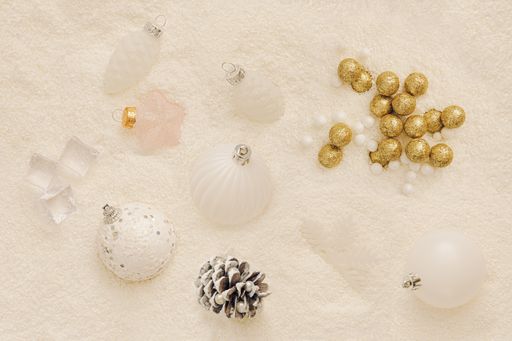 A top view of New Year decorations and balls in on the background of milky white artificial snow
