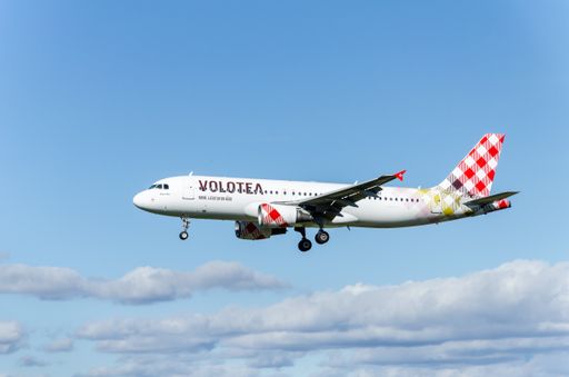 An Airbus A320 plane of the Volotea airline landing at Josep Tarradellas airport in Barcelona