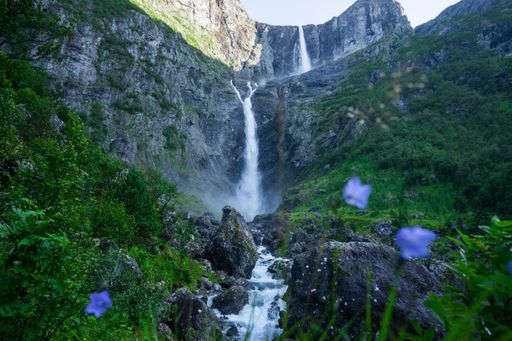 One of the highest waterfalls in Norway, Mardalsfossen, a summer landscape with a large waterfall with dense green vegetation and mountainous terrain