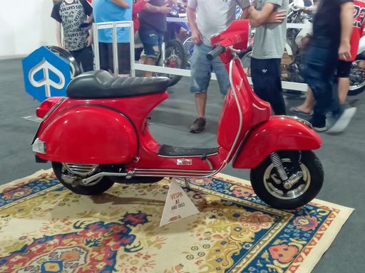 shot of a classic Italian red Vespa A1 scooter 1993 by Piaggio. Expo Wheels 2021 motorbikes show.