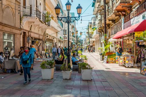 The authentic street shot of people and colonial buildings in El Conde street in the Colonial Zone. Santo Domingo, Dominican Republic