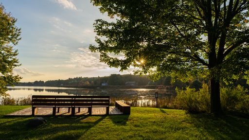 A mesmerizing sunset view over the calm lake in Northeast Pennsylvania captured from the park