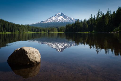 A beautiful view of the mountain reflected in the lake under the blue sky